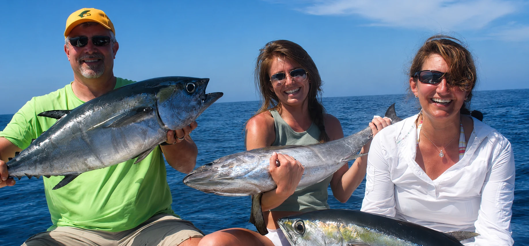 Group holding tuna on a Barracudaville fishing charter